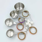 African Grey parrot playing with stainless steel cup bird toy