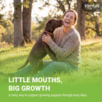 Puppy eating Tomlyn Nutri-Cal gel from a finger