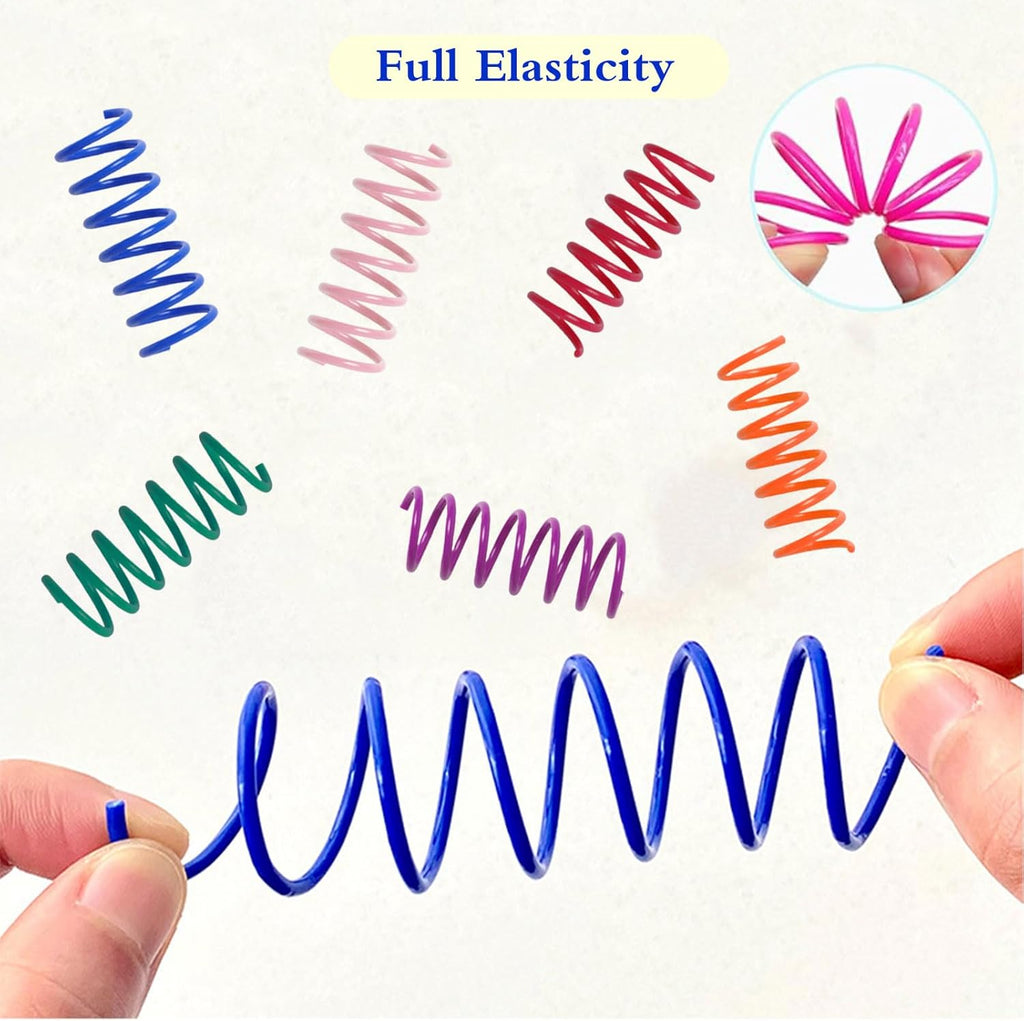 Indoor cat batting an interactive pink plastic coil spring toy during independent self play.