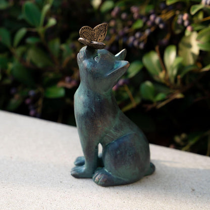 Detailed view of cat statue face and butterfly