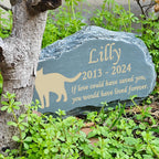 Mountain shape pet grave marker placed beautifully in an outdoor garden flower bed