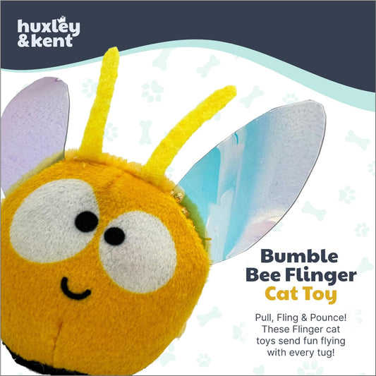 Huxley & Kent interactive catnip toy being pulled back by its elastic band for launching.