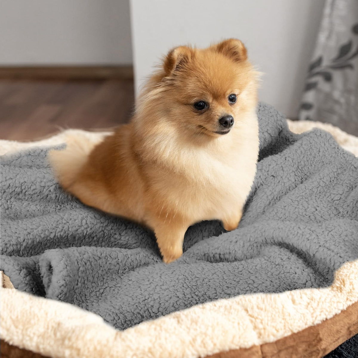 Furrybaby grey pet blanket being placed inside a travel crate
