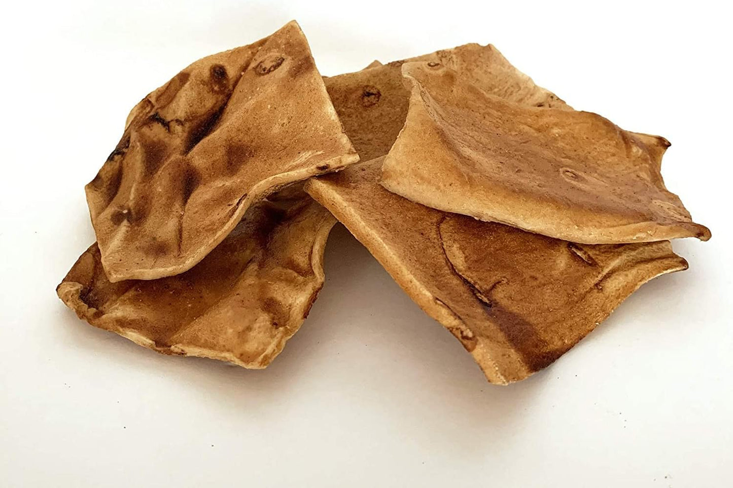 Golden retriever chewing on an authentic American beefhide chip treat.