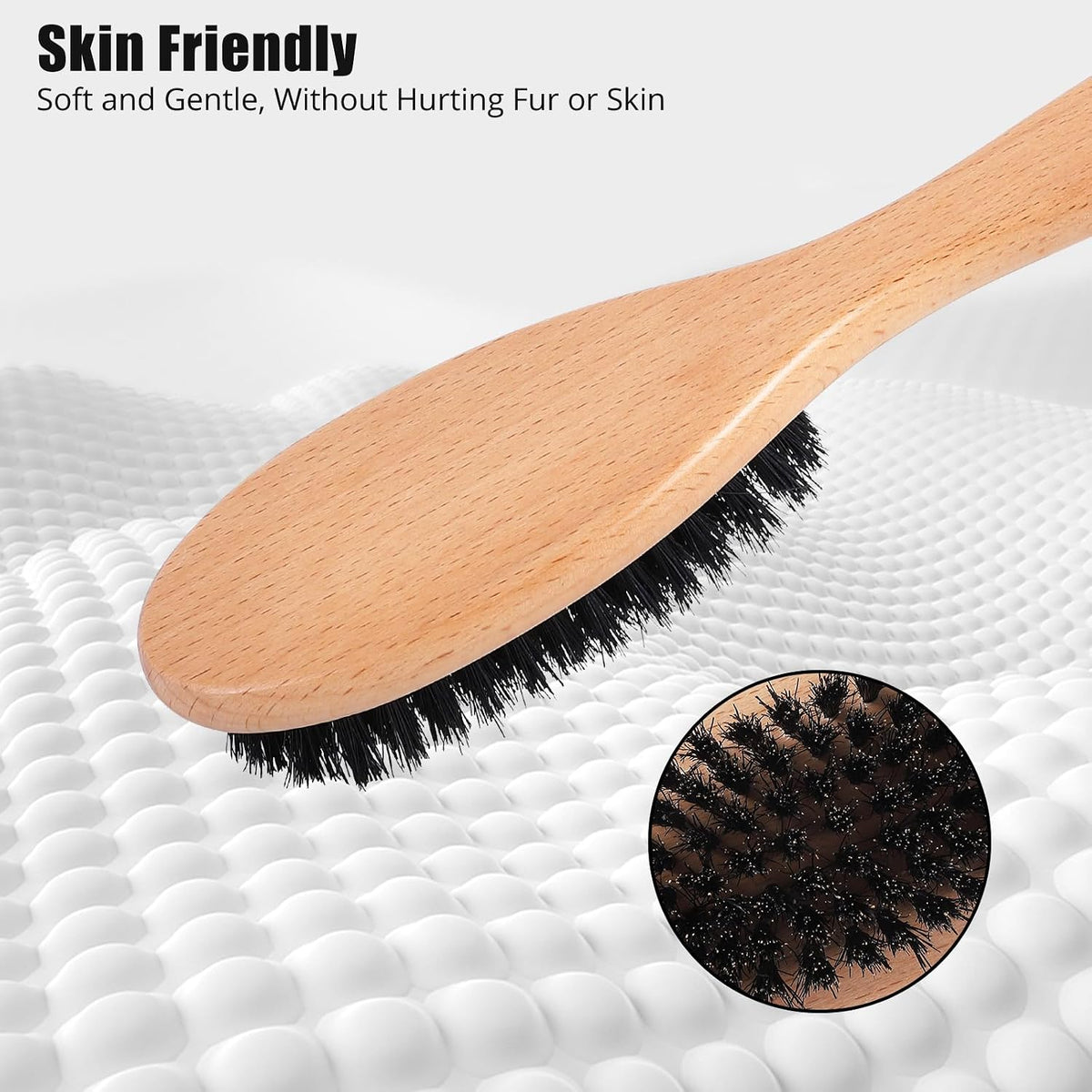 Myselect wooden handle brush being used gently to groom a short haired kitten.