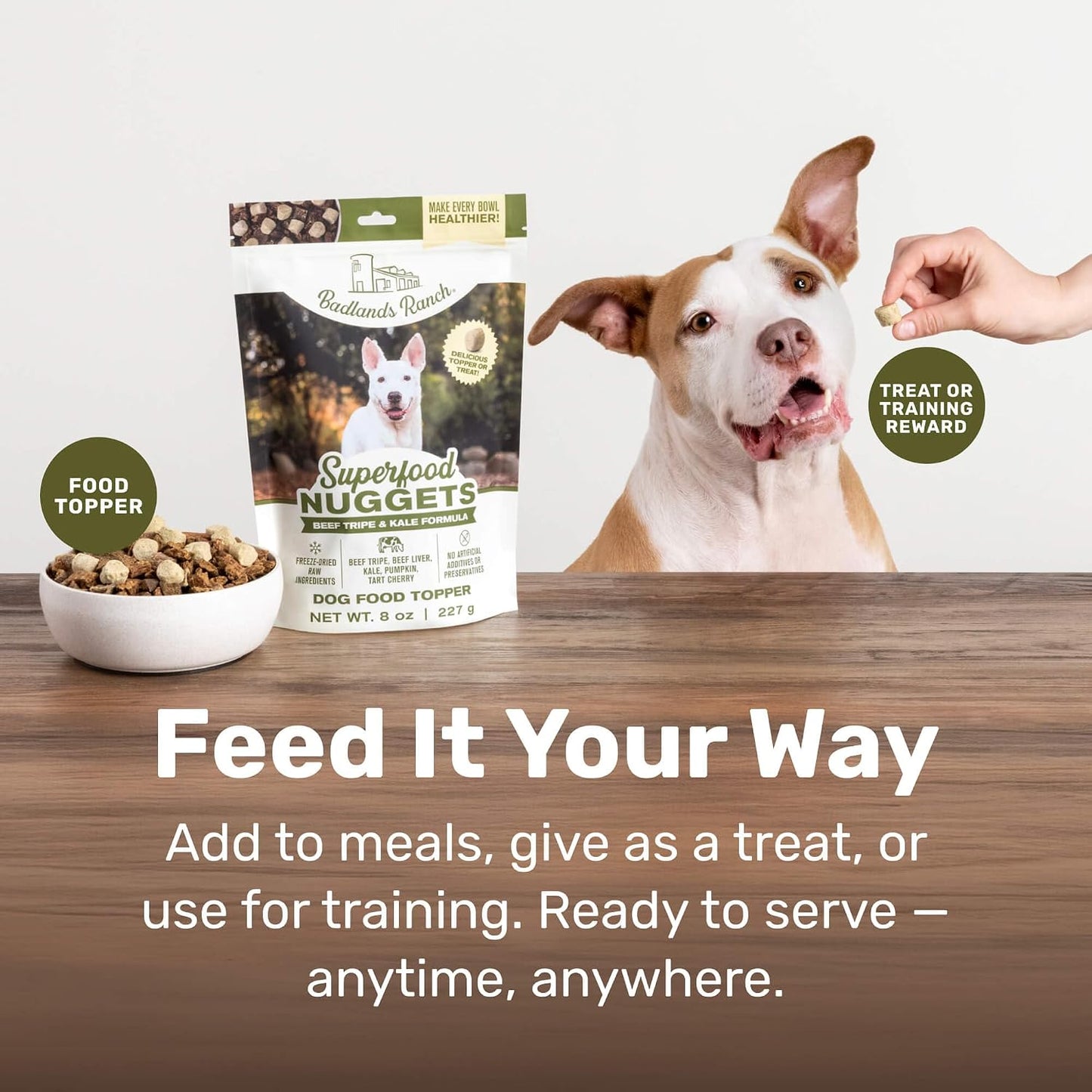 Healthy dog eating food with Badlands Ranch topper