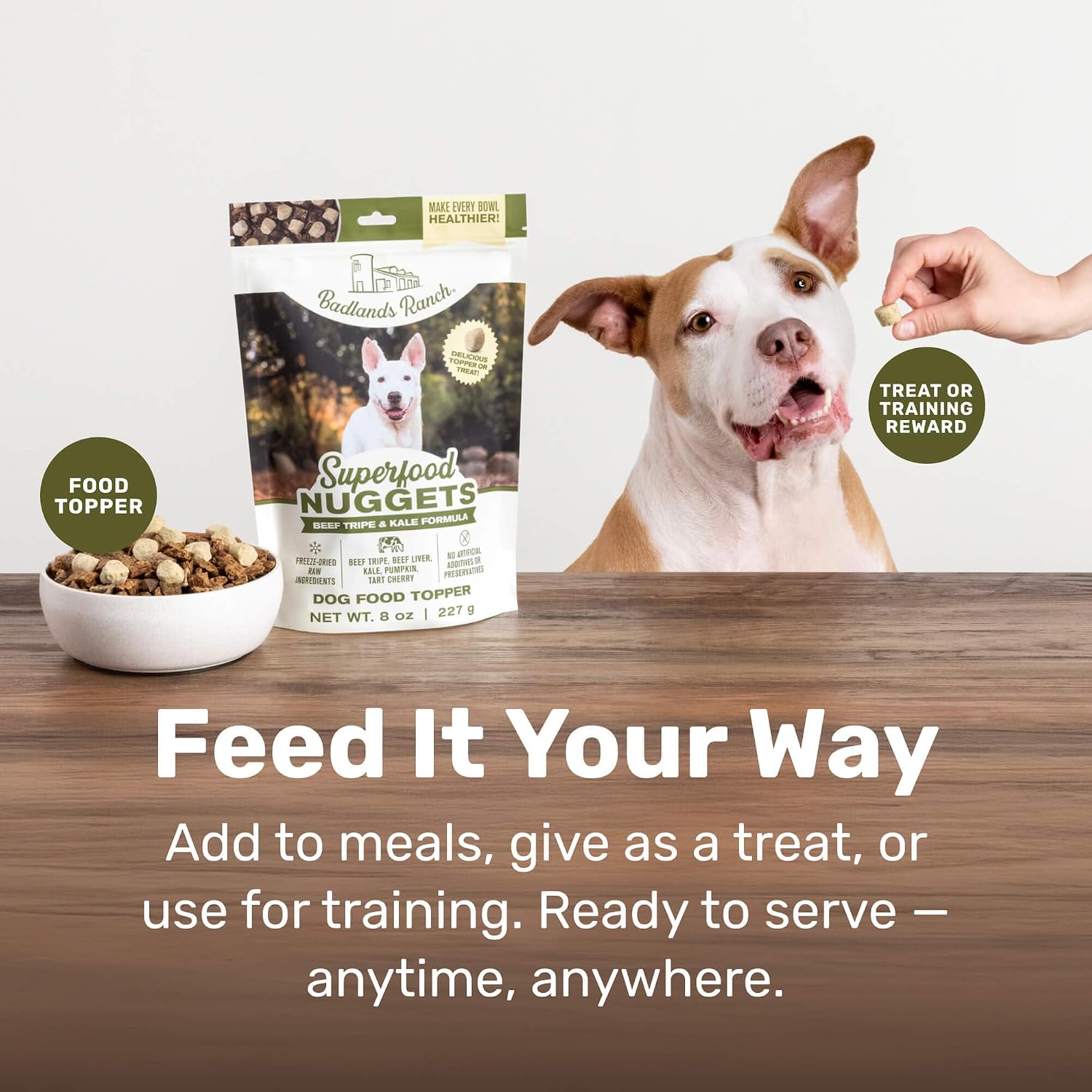 Healthy dog eating food with Badlands Ranch topper