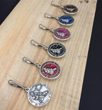 The Christian Mint protective saint charm attached to a dog collar ring