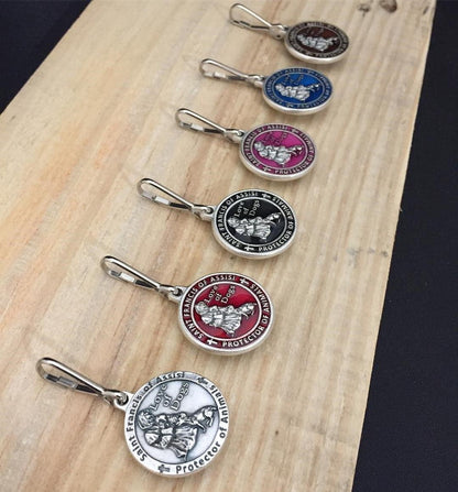 The Christian Mint protective saint charm attached to a dog collar ring