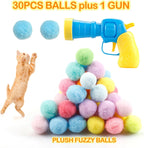 A person loading a nylon pom pom ball into the MeoHui cat toy launcher.