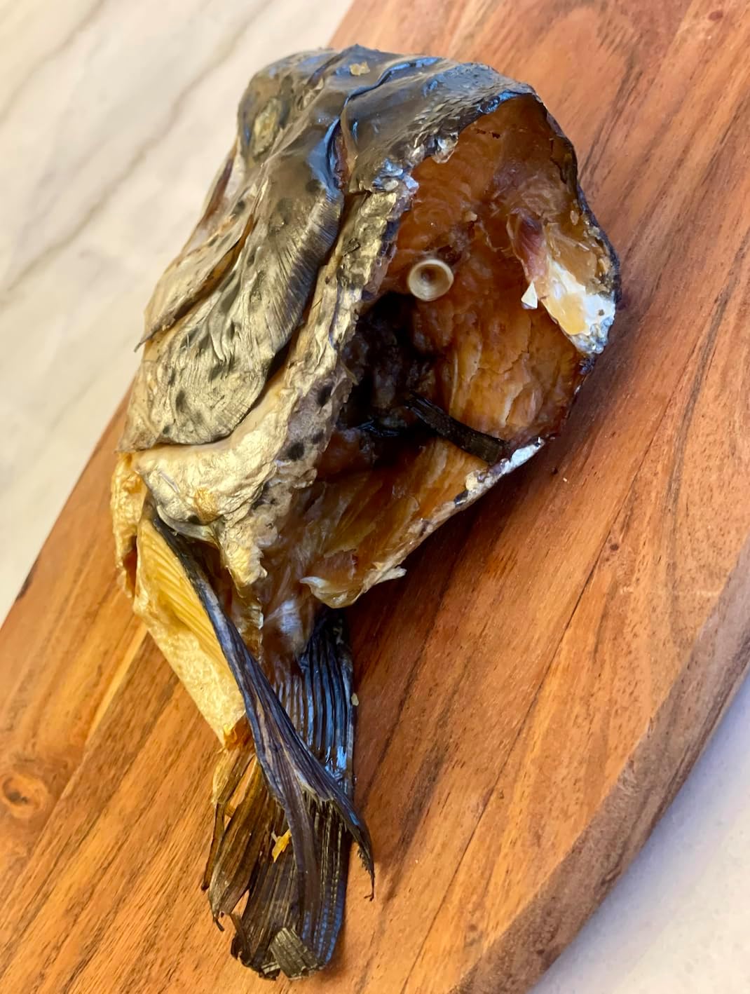 Cat safe serving suggestion of flaked salmon head treat