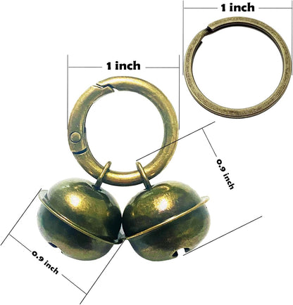 Two pack loud pet tracking bells with quick clip attached to a classic dog collar strap.