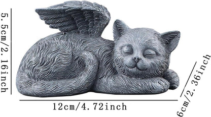 Resin angel cat grave marker placed in a green garden setting.