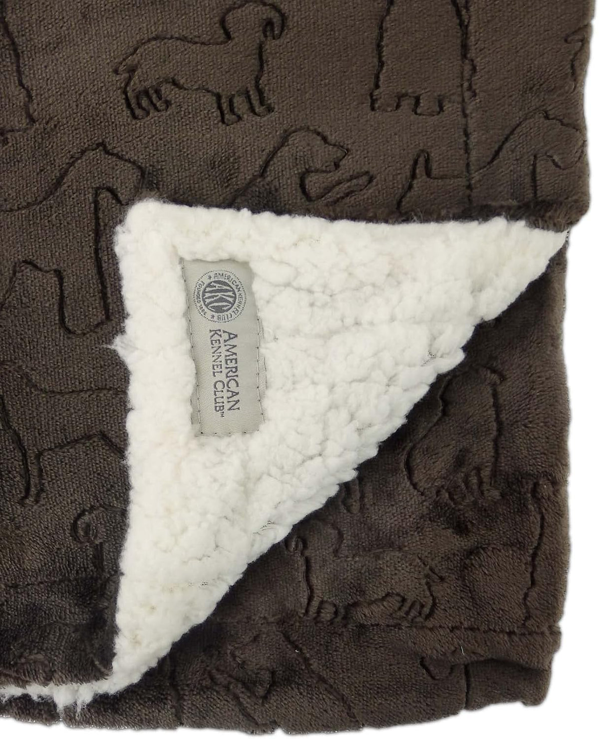 Reversible self-warming brown pet throw blanket draped neatly over a living room sofa