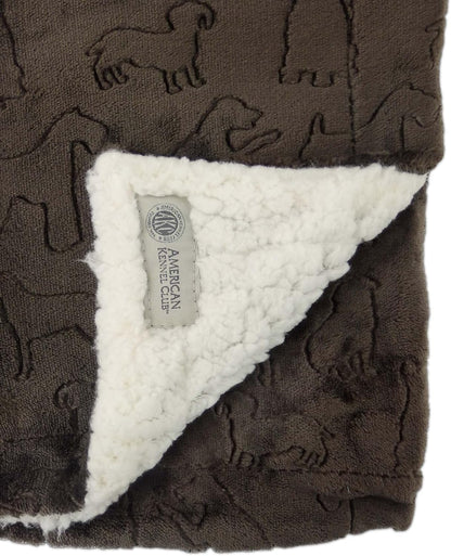 Reversible self-warming brown pet throw blanket draped neatly over a living room sofa
