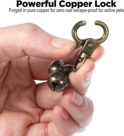 Authentic Maxqzin copper pet bell with snap clips demonstrating how it hooks to standard collar rings.