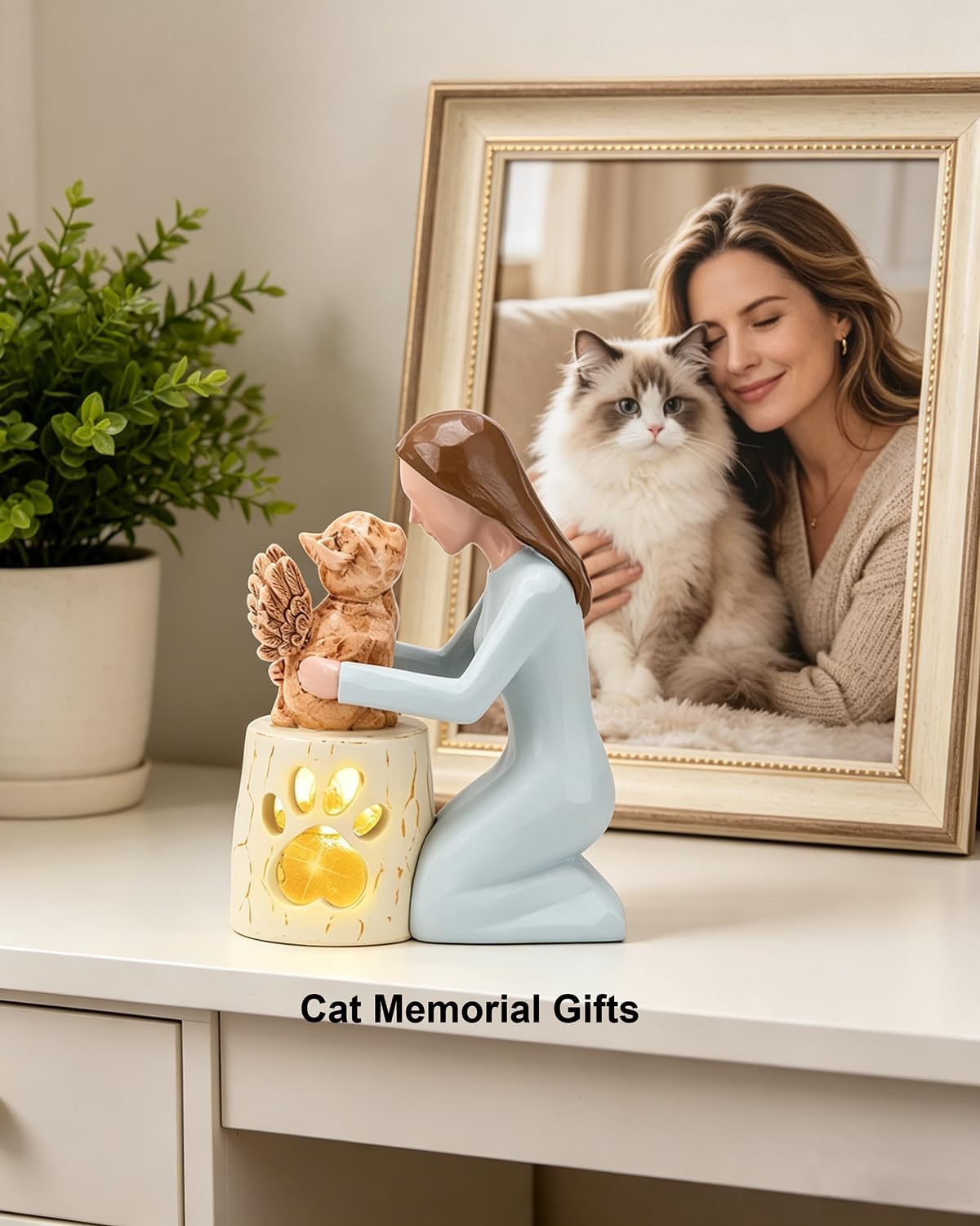 Close up of wood carving style resin woman and winged cat figurine