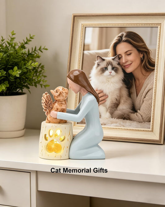 Close up of wood carving style resin woman and winged cat figurine