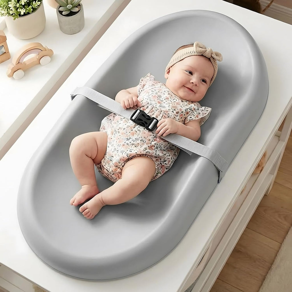 Mallify wipe clean changing pad front view with adjustable safety belt on a dresser