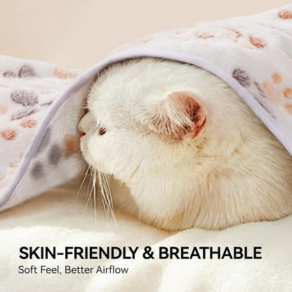 Small puppy resting comfortably on the LINENLUX paw print warm sleep blanket.