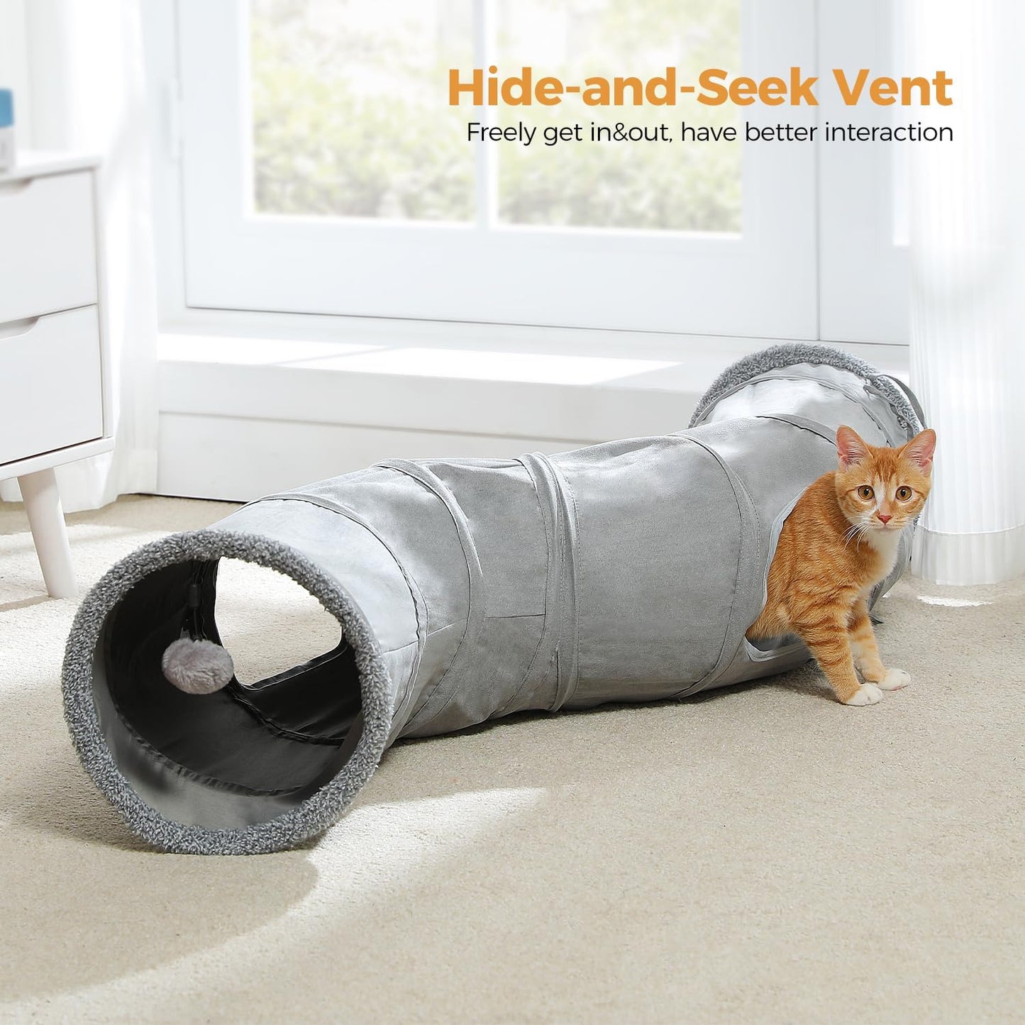 Two indoor kittens playing inside the S-shaped pet tunnel highlighting the dual peek holes.