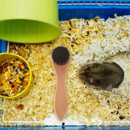 VANZACK wooden handle rabbit brush being used for gentle small animal coat cleaning.