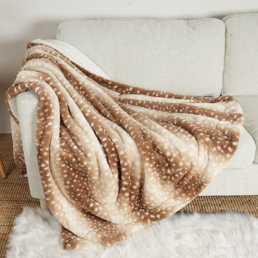 COZY KISS Luxury Faux Fur Waterproof Pet Blanket front view showing brown deer print pattern spread across a sofa.