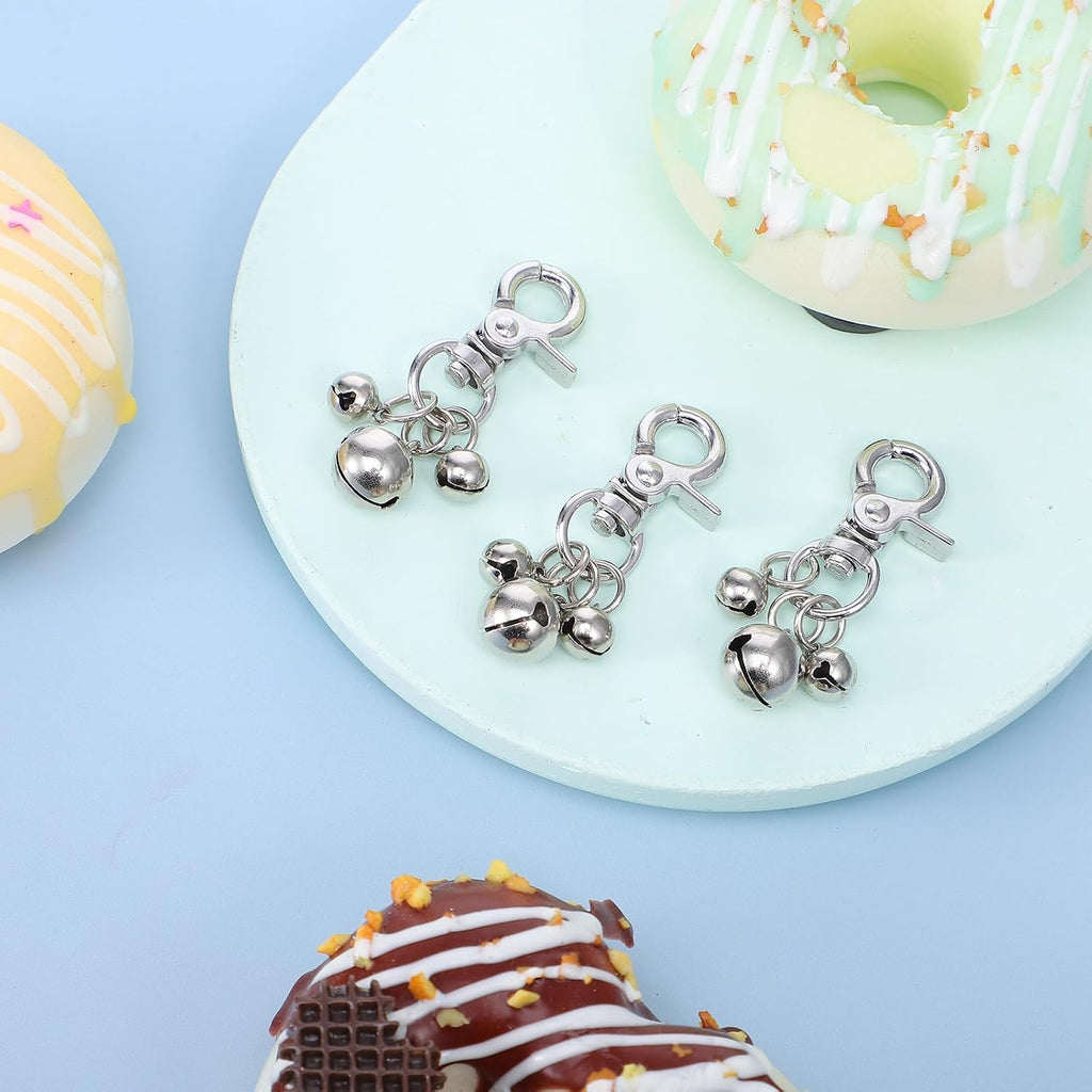 Side view of the sturdy lobster clasp mechanism on the cobee silver pet training bells for secure outdoor activity