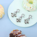 Side view of the sturdy lobster clasp mechanism on the cobee silver pet training bells for secure outdoor activity