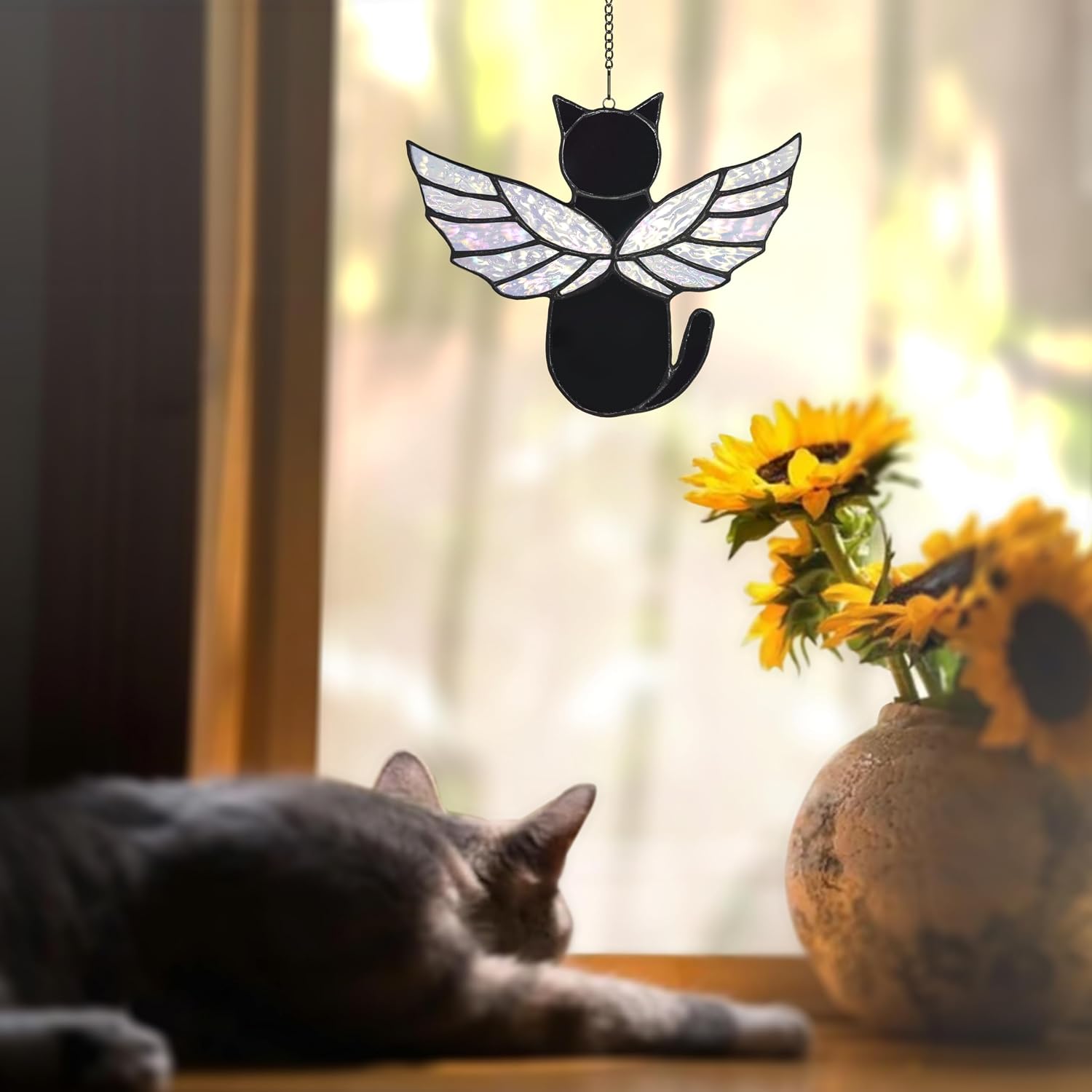 Angel cat glass decor casting a colorful rainbow reflection inside a home