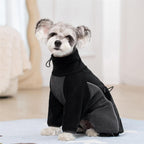 Small dog wearing warm windproof pullover pajamas.