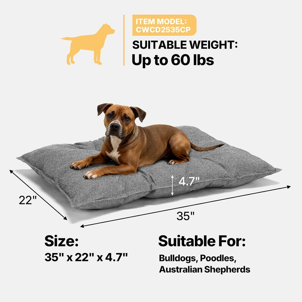 Grey indestructible dog bed inside a wire crate