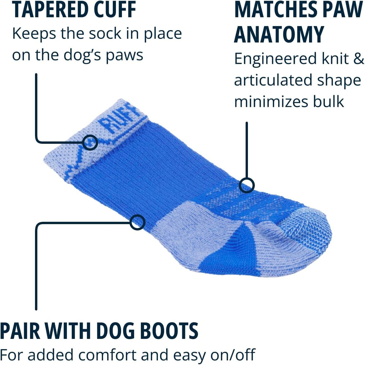 Side profile of canine paw wearing blue Ruffwear boot liner