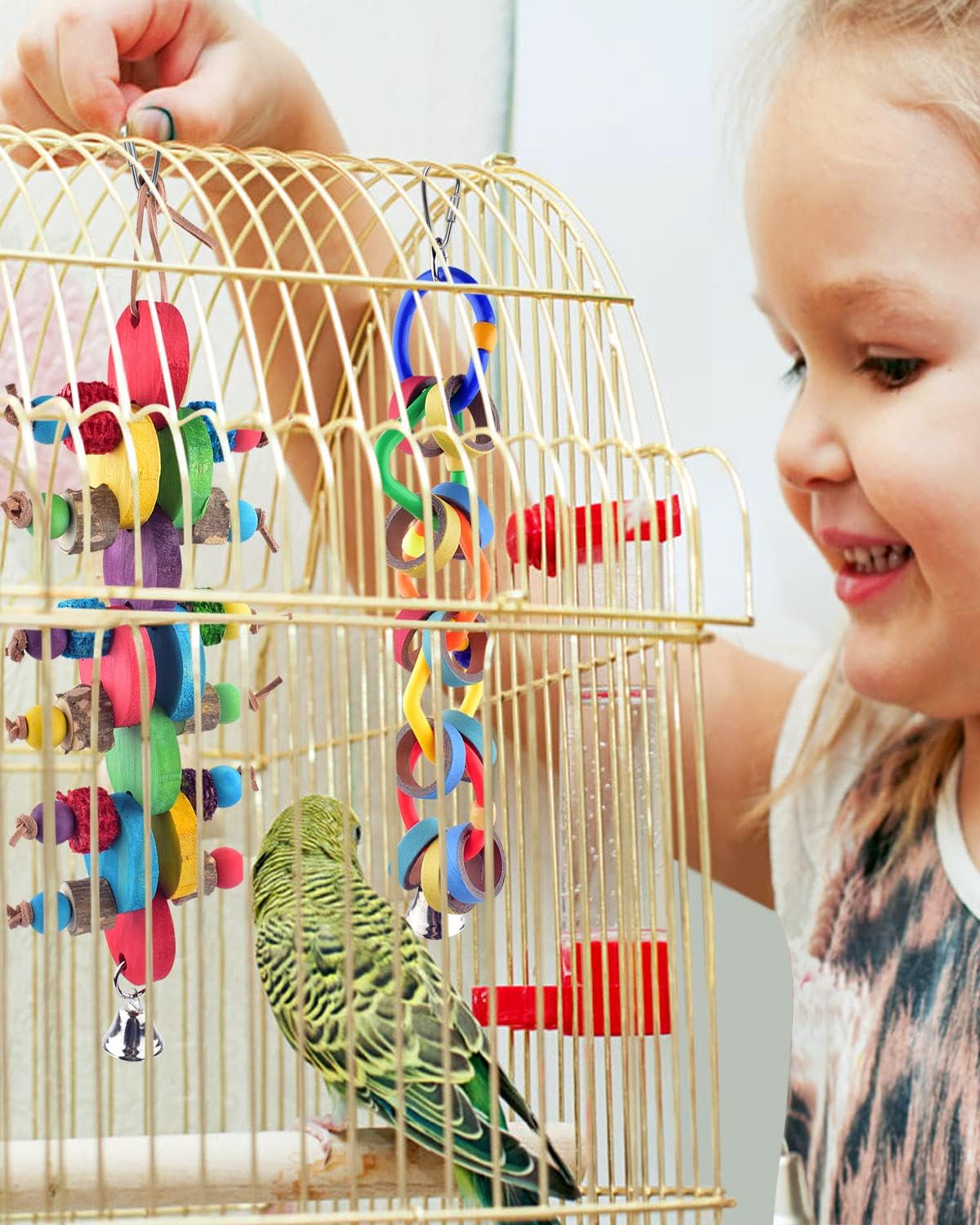 Side view of Bissap bird enrichment toy in cage