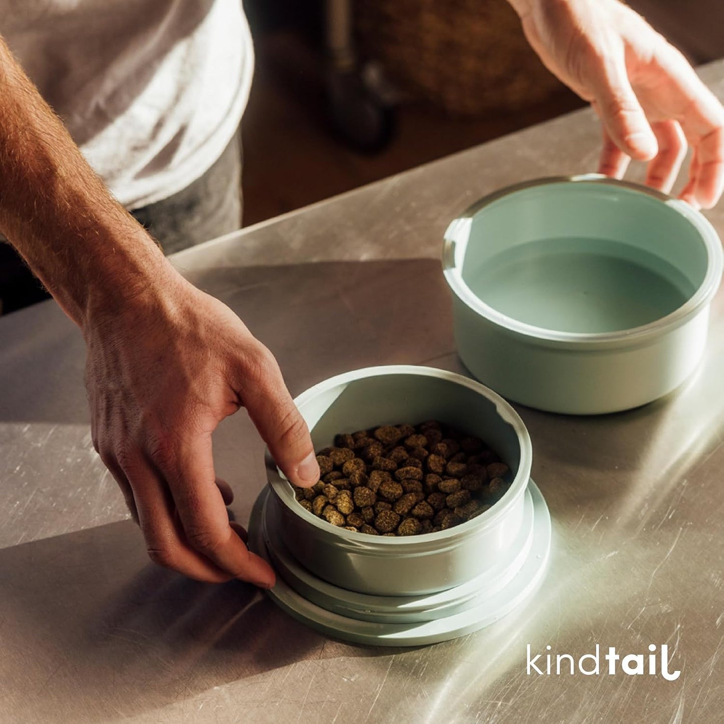 Eco-friendly recycled material pet feeding set in lifestyle travel setting.