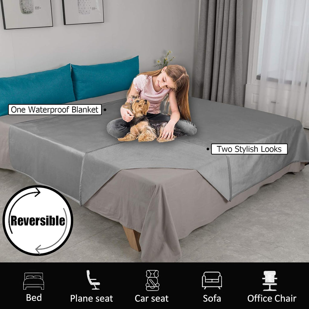 Machine washable grey pet blanket spread across a clean white bed.