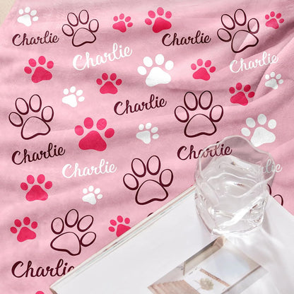 Small puppy snuggling comfortably under the GlisterGlow personalized flannel blanket