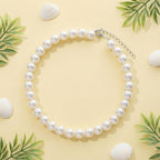 Fengek domestic cat wearing elegant ten millimeter faux pearl costume accessory.