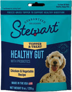 Stewart freeze dried dog topper being sprinkled over dry kibble in a bowl