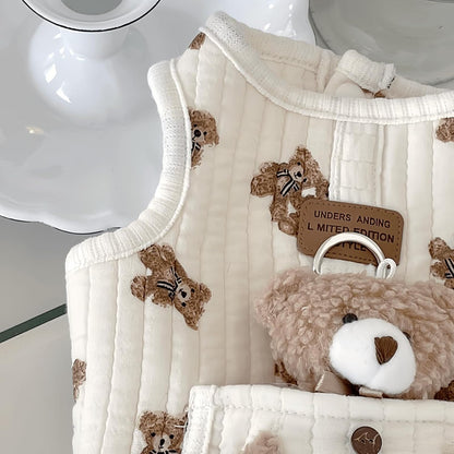 Small puppy wearing white bear pattern sleeveless vest