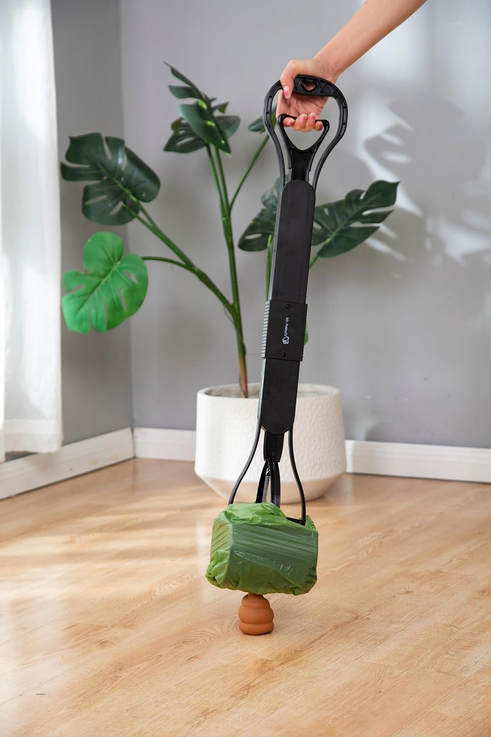 Mr. Peanut's pet waste picker highlighting the durable double spring jaw clamp mechanism.