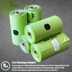 Two green dispenser capsules and two black leash clips laid out next to the packaging.