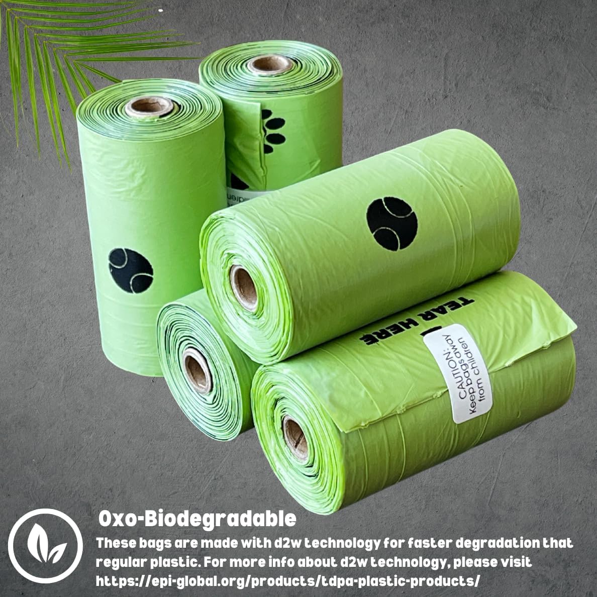 Two green dispenser capsules and two black leash clips laid out next to the packaging.