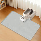 Top view of the 34 inch by 20 inch grey silicone cat mat trapping scattered granules.