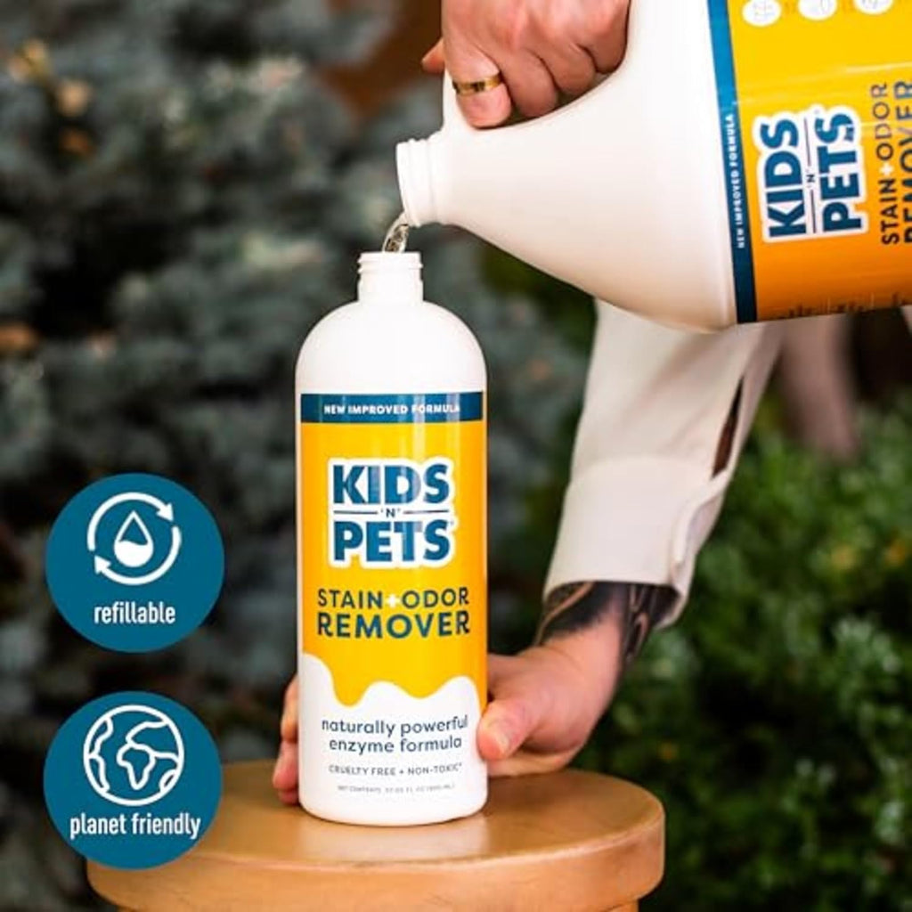 Kids 'N' Pets stain remover bottle being used on a carpet stain