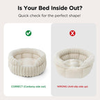 Cat resting comfortably inside cream colored round pet bed