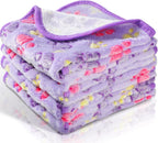 Flannel style pet bedding used as a protective cover on a living room sofa.