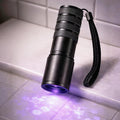 Generic portable blacklight flashlight front view highlighting the twelve light emitting diode bulbs for pet stain detection.
