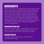 Cat eating Wellness chicken lickable puree from bowl