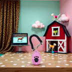 Teardrop shaped pink puppy training clicker showing paw print pattern